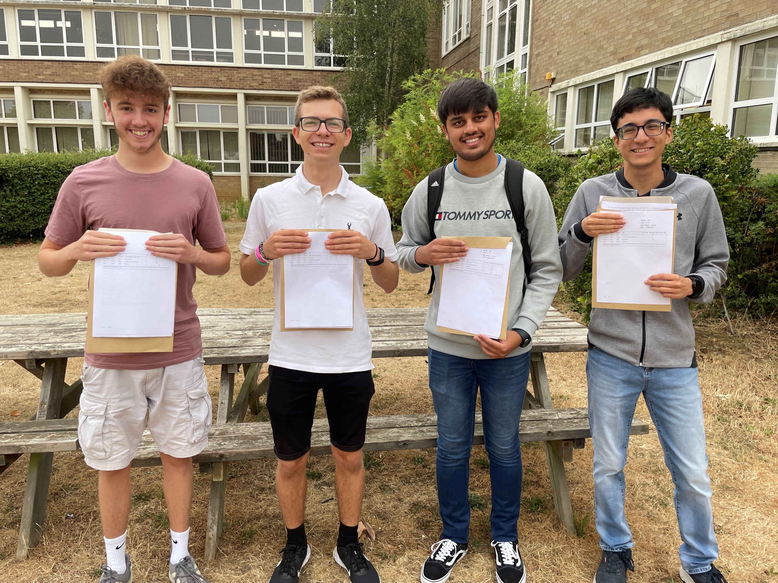 Happy students from Stratton Upper School holding their exam certificates