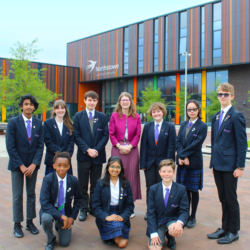 A photo of Headteacher Carole Moss and several students outside Northstowe Secondary College.