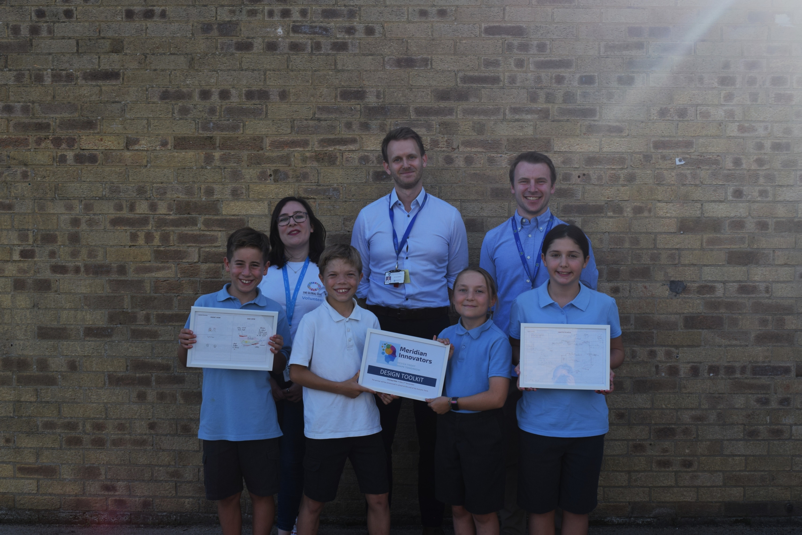 A pictures of four pupils and three adults